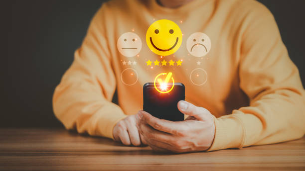 istock Man using a mobile phone in give rating to service experience on application. Online customer review satisfaction feedback survey and testimonial. 1455128380