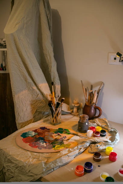 istock the artist's desk. Brushes. Mixed colors on the palette. 1455135405
