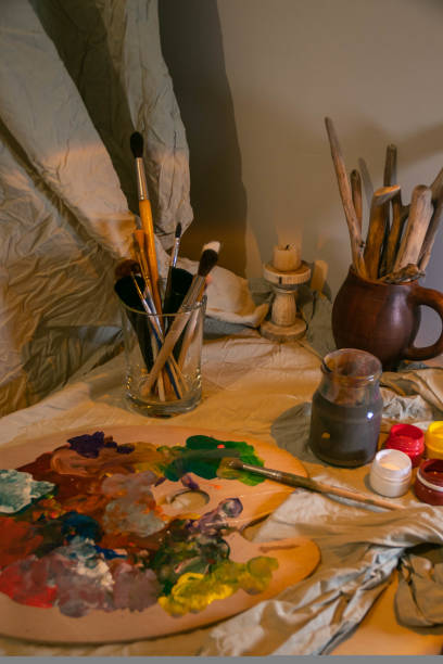 istock the artist's desk. Brushes. Mixed colors on the palette. 1455135434