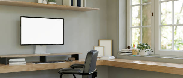 istock Minimal and comfortable home working room with computer corner desk against the window 1455136829