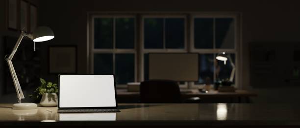 istock Portable tablet mockup with wireless keyboard on tabletop over dark office in the background. 1455137526