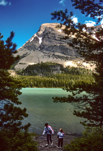 Glacier NP - Sisters Discover Swiftcurrent Lake - 1989. Scanned from Kodachrome 64 slide.