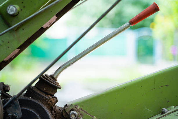 Gear lever on a walk-behind tractor close-up on a blurred background. Control elements of agricultural machinery. Rototiller connection and gear shifting