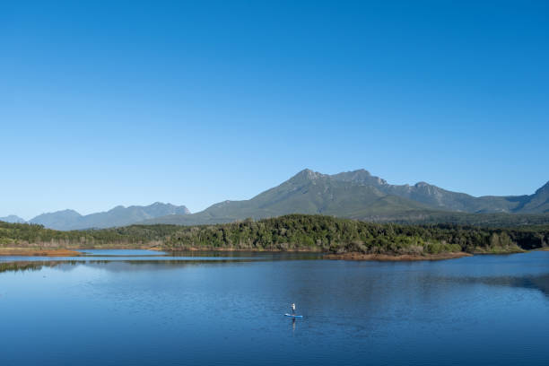 istock Paddle boarding on a large lake in the mountains. 1455149640