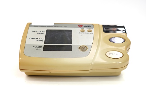 The image shows a 1st generation digital sphygmomanometer device on a white background, close up.