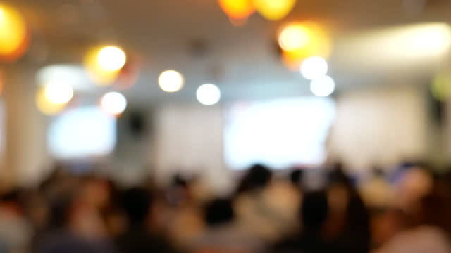 Blur background seminar business event in auditorium  hall convention audience presentation meeting at conference room present screen for entrepreneurs startup business. Blurred background copy space