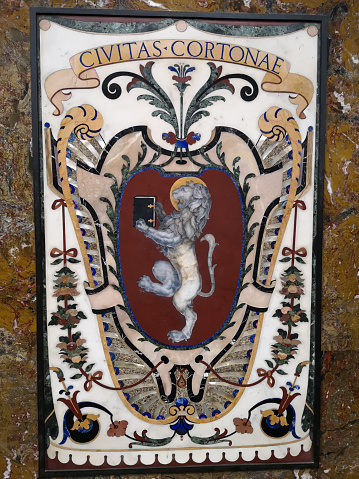 Emblem of the town of Cortona in the octagonal Cappella dei Principi at the Medici Chapels (Cappelle medicee) two structures at the Basilica of San Lorenzo, Florence, Italy, dating from the 16th and 17th centuries, with the purpose of celebrating the Medici family, patrons of the church and Grand Dukes of Tuscany.
