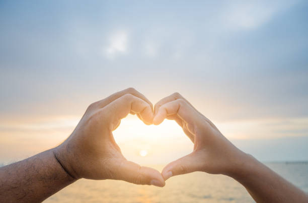 istock couple holding hands in heart shape on valentines day 1455150749