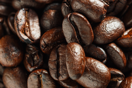 Glass cup of black coffee with coffee bean background. Viewed from directly above.