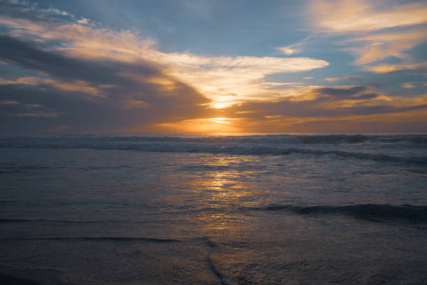 istock Golden sunset over the sea with beautiful cloudy sky on background. Amazing tranquil scene in soft light colors, copy space 1455152167