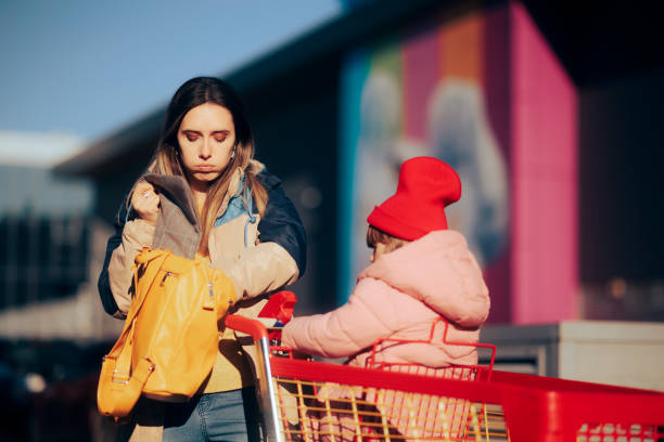 istock Forgetful Mother Checking Her Bag Looking for Shopping Money 1455153754