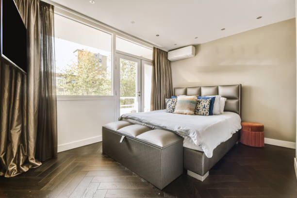 istock a bedroom with a bed and a large window 1455154803