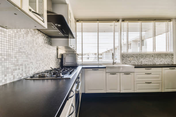 istock a kitchen with white cabinets and a black counter top 1455154908