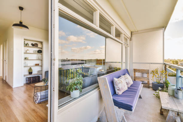 istock a balcony with a purple couch and a large window 1455156123