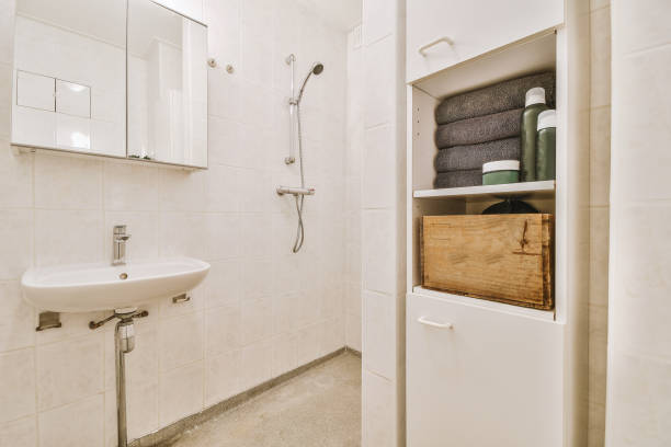 istock a small white bathroom with a sink and a shower 1455156131