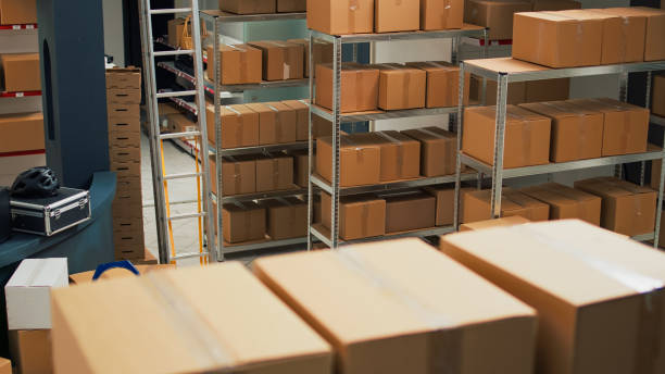 istock Storage room space filled with carton packages on shelves and racks 1455159541