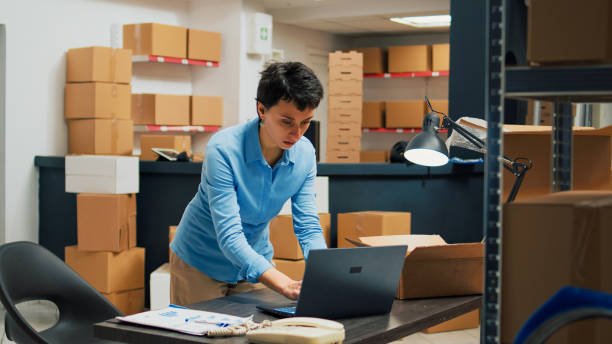 istock Caucasian woman putting merchandise in packages 1455160420