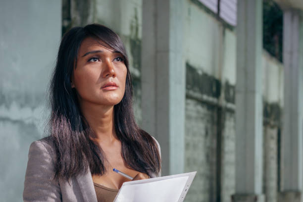 istock Portrait of Asian transgender engineer taking notes on construction site 1455167112