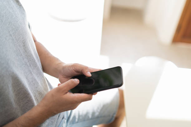 istock Close up man hold mobile phone text or message on white screen. Businessman use modern smartphone to browse web, read e-book, trade stocks, trade crypto currency. Business communication concept. 1455168016