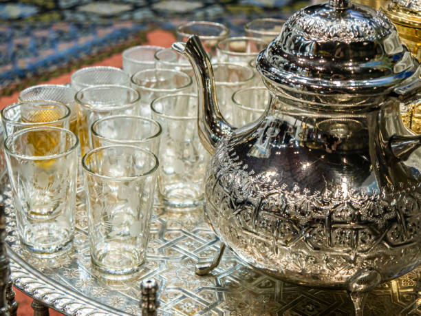 bule de chá tradicional marroquino decorado com bule de chá e copos em uma bandeja no estande de marrocos na fitur 2022 - international tourism trade fair - fotografias e filmes do acervo