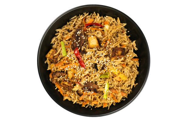 istock Khao pad. Vegetarian dish in a black plate on a white background. Thai dish. 1455173936