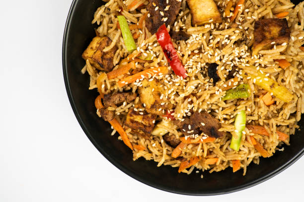 istock Khao pad. Vegetarian dish in a black plate on a white background. Thai dish. 1455173948