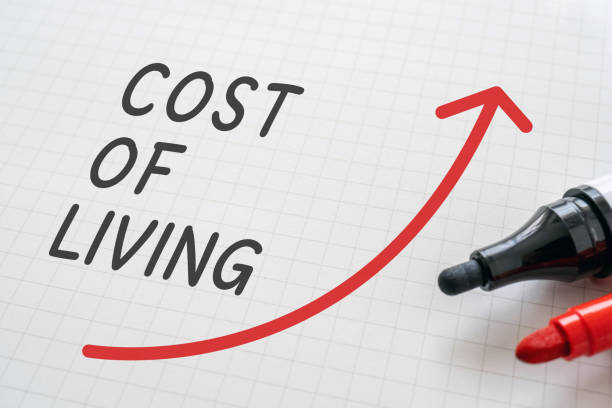 White paper written "COST OF LIVING" with markers. White paper written "COST OF LIVING" with markers. cost of living stock pictures, royalty-free photos & images