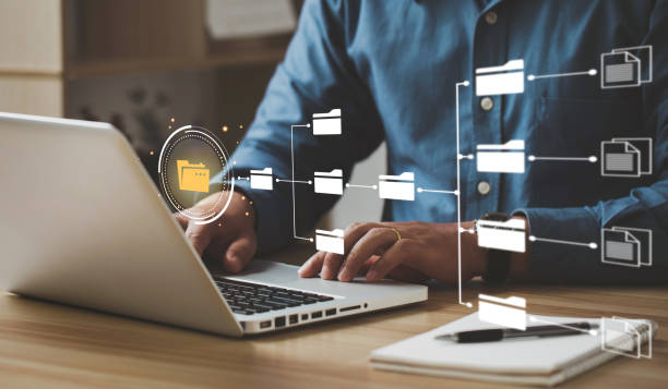 Businessmen use laptops to access information in online documents. through the protection system.Document Management System (DMS), online documentation database, and digital file storage system.