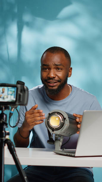 istock African american blogger reviewing studio light on camera 1455183020