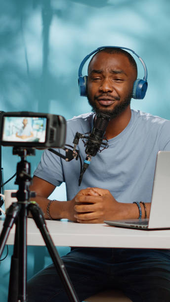 istock Vlogger recording video on camera with tripod in studio 1455183639