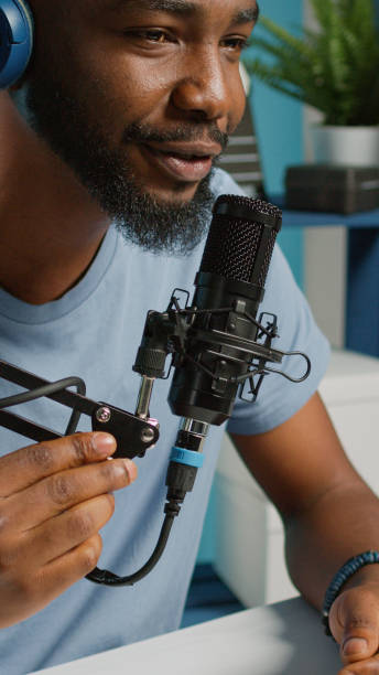 istock Close up of vlogger using microphone and headphones 1455183671