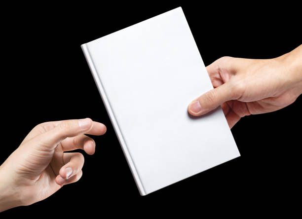 istock Hands sharing white hardcover book on black 1455183799