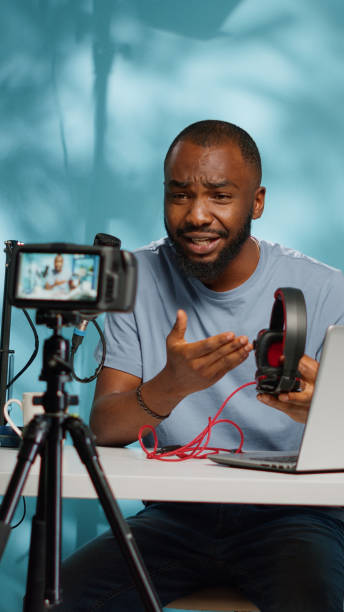 istock Content creator holding headphones for product review 1455183864