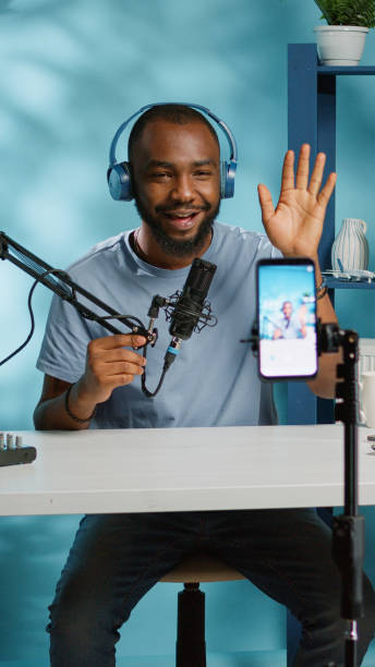 istock African american vlogger using smartphone to film podcast 1455183889