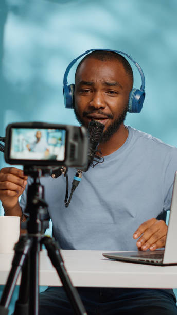 istock African american vlogger using camera to record video 1455183894