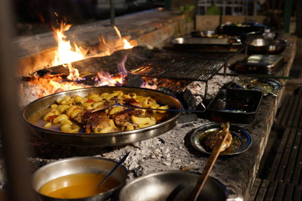istock Barbecue grill with flames, potatoes, meats, and sauces 1455192363