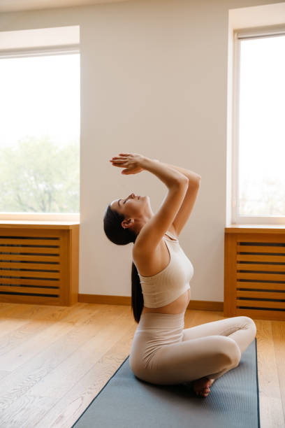 istock Young white woman doing exercise on mat during yoga practice 1455193001