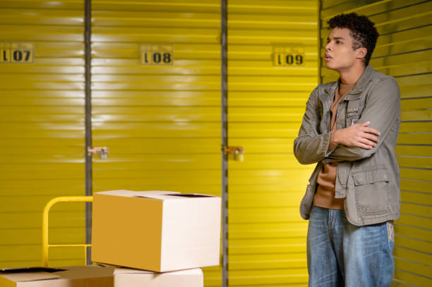 istock Warehouse worker trying to open the locker and looking puzzled 1455195219