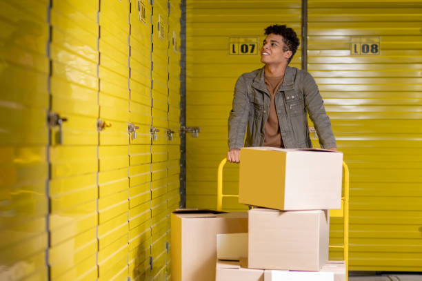 istock Young smiling man working in a warehouse and distributing boxes 1455195239