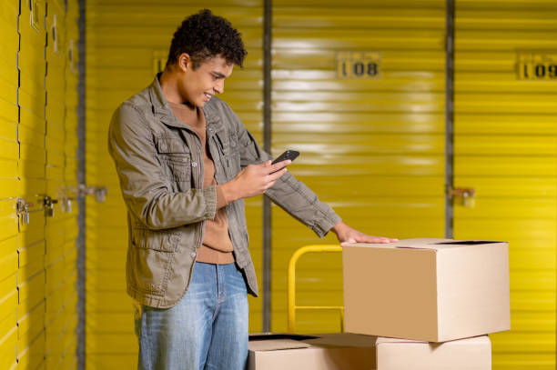 istock Curly-haired young service man making picture of the boxes 1455195281