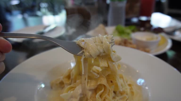 close up eating pasta at restaurant