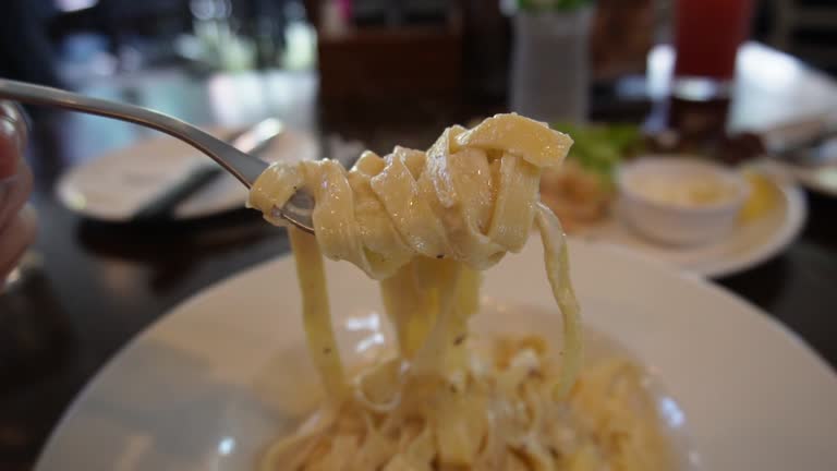 close up eating pasta at restaurant