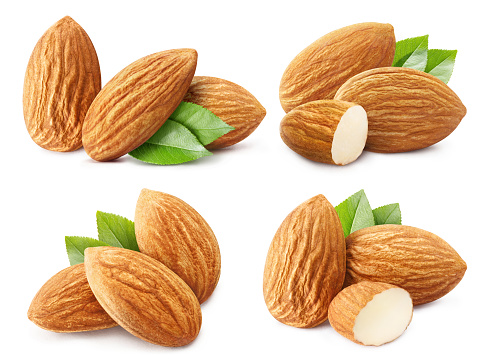 Collection of delicious almonds with leaves, isolated on white background