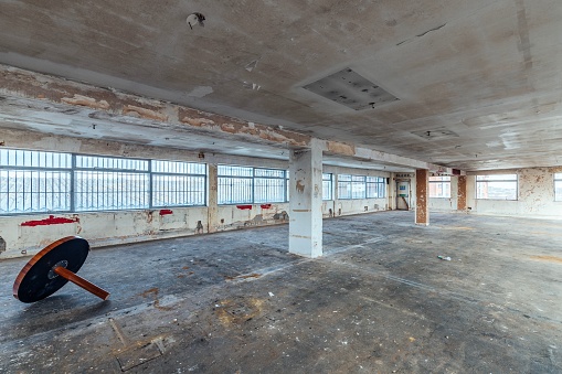 A wide-angle shot of ainterior of an abandoned commercial office space in need of works in London, England, United Kingdom