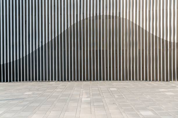 istock Smooth concrete floor against the textured wall. 1455198173