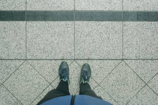 istock Top view of a person's feet on a concrete ground 1455198564