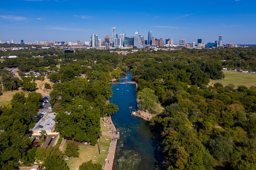 A beautiful distant view of the Barton Creek and a skyline of Austin, Texas
