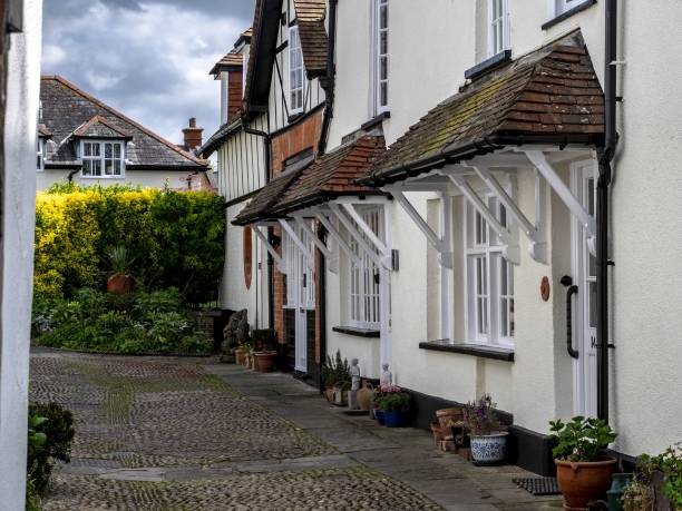 istock Old Wood Framed Cottages With Whitewashed Walls And Cobbled Courtyard In Topsham Devon UK 1455199734