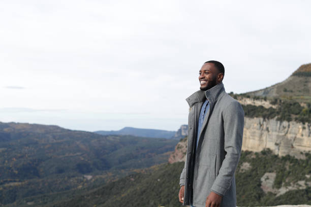 istock Happy black man contemplating in winter in nature 1455200100
