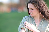 Woman complaining scratching arm